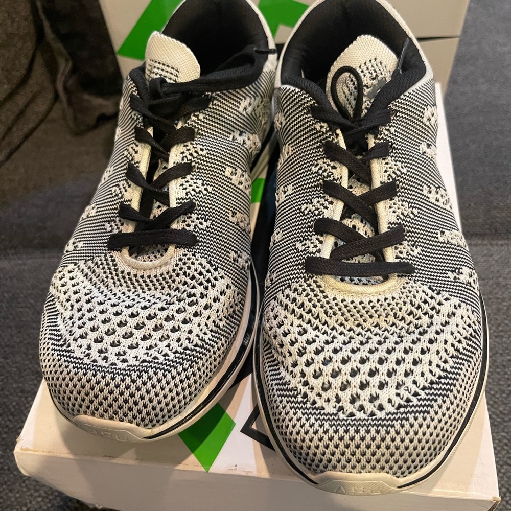 Black and white women’s APL sneakers